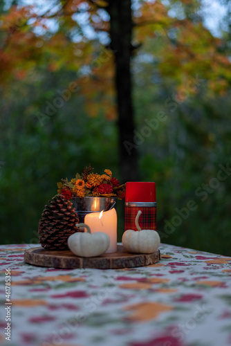 Candlelight picnic outdoors in autumn with rustic decorations