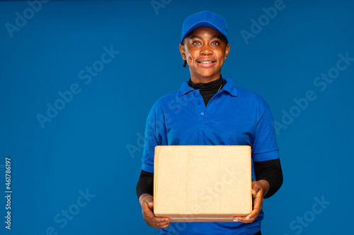beautiful african delivery worker holding a parcel