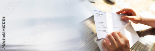 Businessperson Opening Envelope With Paycheck