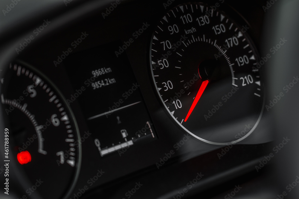 Close up view of a speedometer in a car. Kilometer counter. Car speedometer and dashboard.