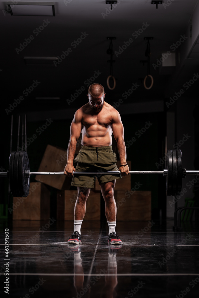 Muscular athlete lifting very heavy barbell Muscular athlete lifting very heavy barbell