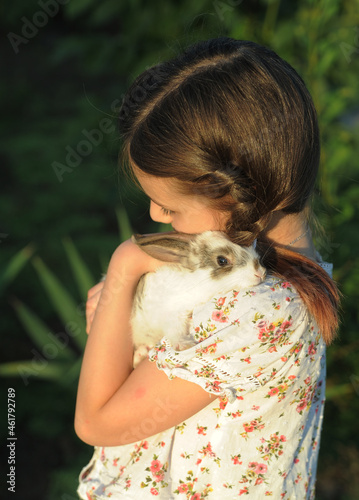 Rabbit symbol of Easter. Friendship between child and animal concept.	