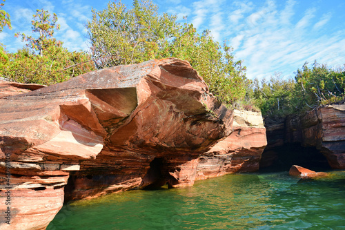 the colorful, eroded sea caves of devil's island on a sunny fall day in the apostles islands in lake superior off the bayfield peninsula in northern wisconsin photo