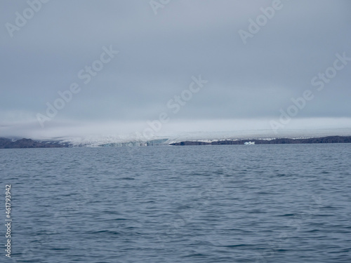 photo of mountain, glacier, sea ice, ocean and icebergs in the canadian arctic