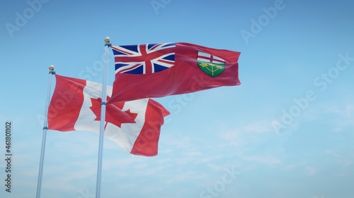 Photography Waving flags of Canada and the Canadian province of Ontario against blue sky backdrop