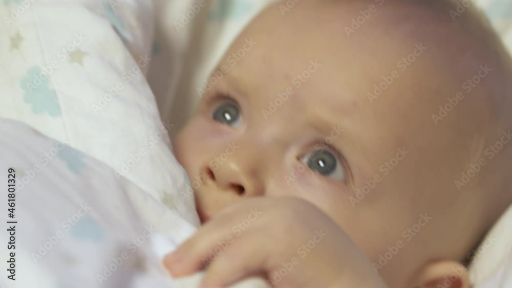 Baby falling asleep in baby rocker afternoon nap, caucasian six month old infant face closeup. High quality 4k footage Baby falling asleep in baby rocker afternoon nap, caucasian six month old infant face closeup. High quality 4k footage