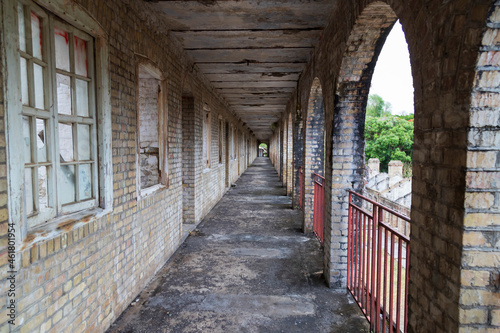 long corridor surrounded by arches and railings on the right © asa