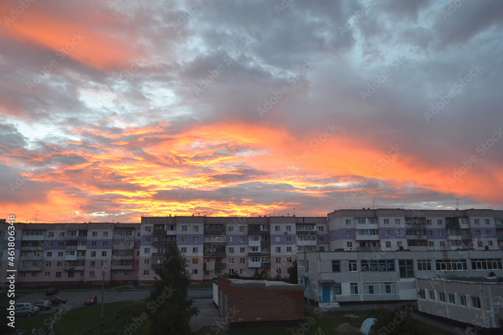 Beautiful sunset over the roofs of the houses of the city of Topki, Kemerovo region. Urban landscape