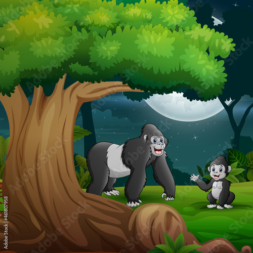 Night forest with a mother gorilla and her cub under the tree