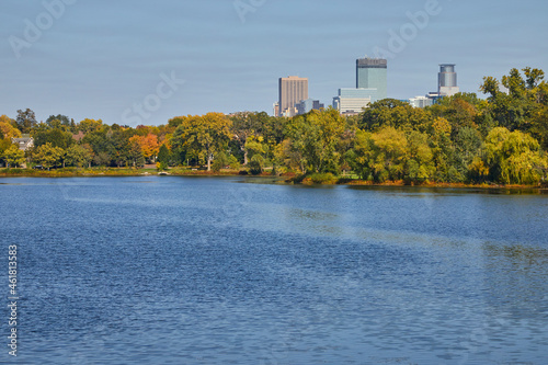 City of Minneapolis skyline on a beautiful day in fall with a lake in the foreground