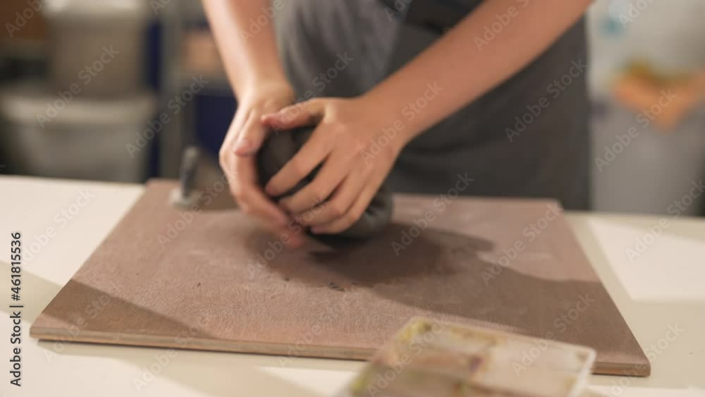 Beautiful Asian woman sculptor artist sculpture clay on pottery wheel at ceramic studio. Female craftsman molding raw clay create pottery shapes at workshop. Small business handicraft product concept.