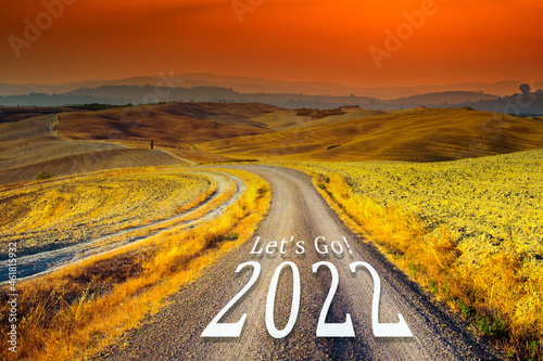 New year 2022 concept. Text 2022 written on the road in the middle of asphalt road at sunset. Concept of planning and challenge