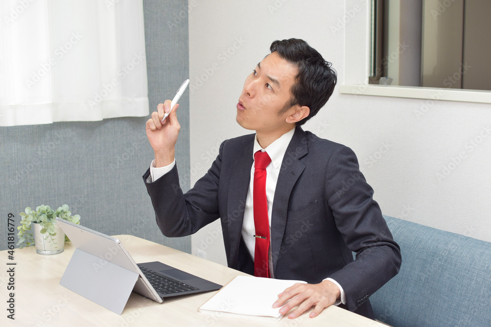 A young Asian man during telework at home comes up with new idea A young Asian man during telework at home comes up with new idea