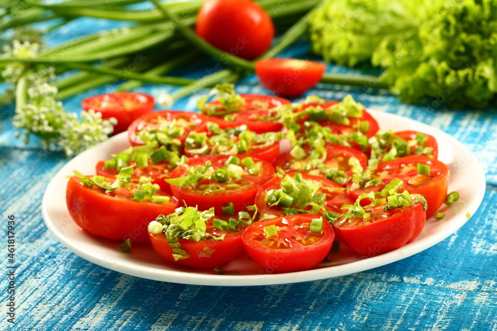 Healthy vegetarian diet meal- homemade organic tomato salad with fresh herbs and greens. Healthy vegetarian diet meal- homemade organic tomato salad with fresh herbs and greens.