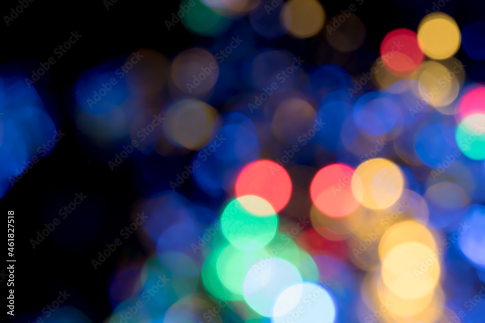 Fototapeta premium Colored blurred bokeh balls with depth and glow on black background for overlay