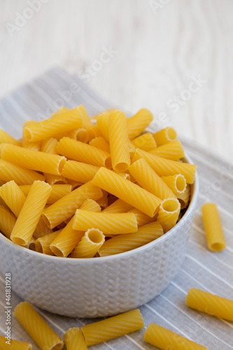 Dry Rigatoni Pasta in a gray Bowl, side view.