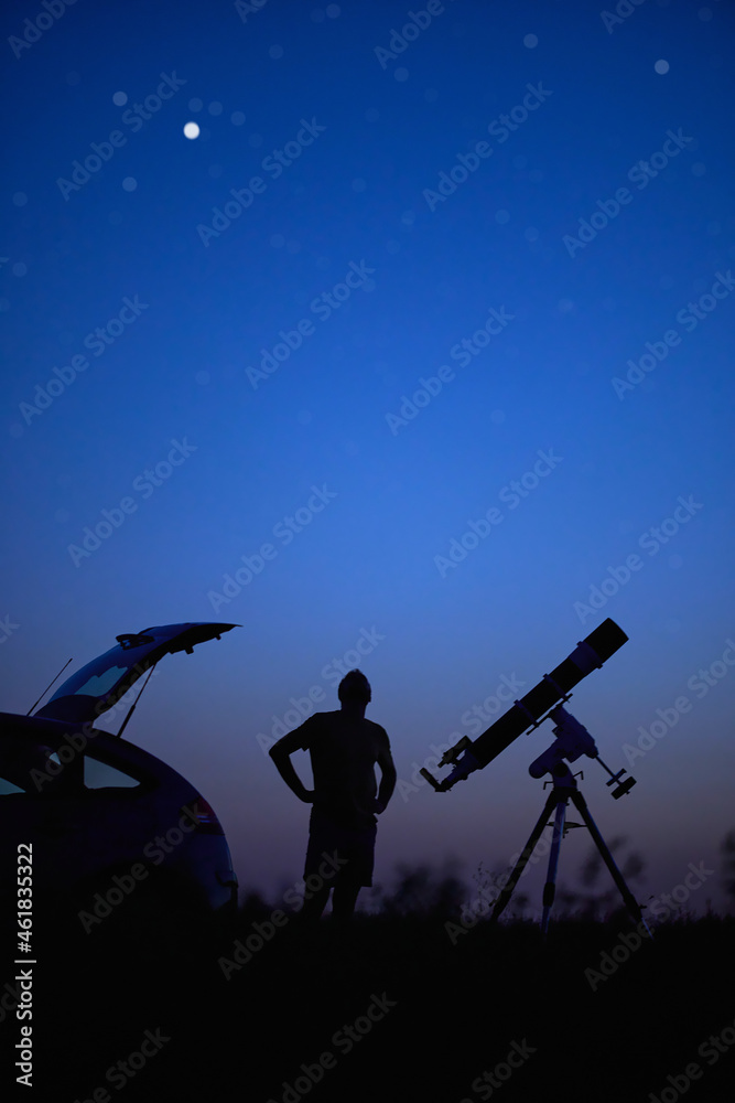 Silhouette of a man, telescope and countryside under the starry skies. Silhouette of a man, telescope and countryside under the starry skies.