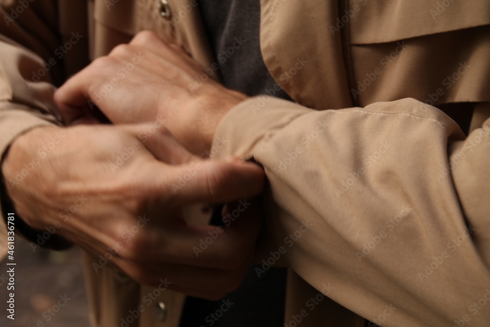hands of a man 
a man's hands buttoning the cufflinks on his coat
businessmen
beautiful male hands in a brown coat



