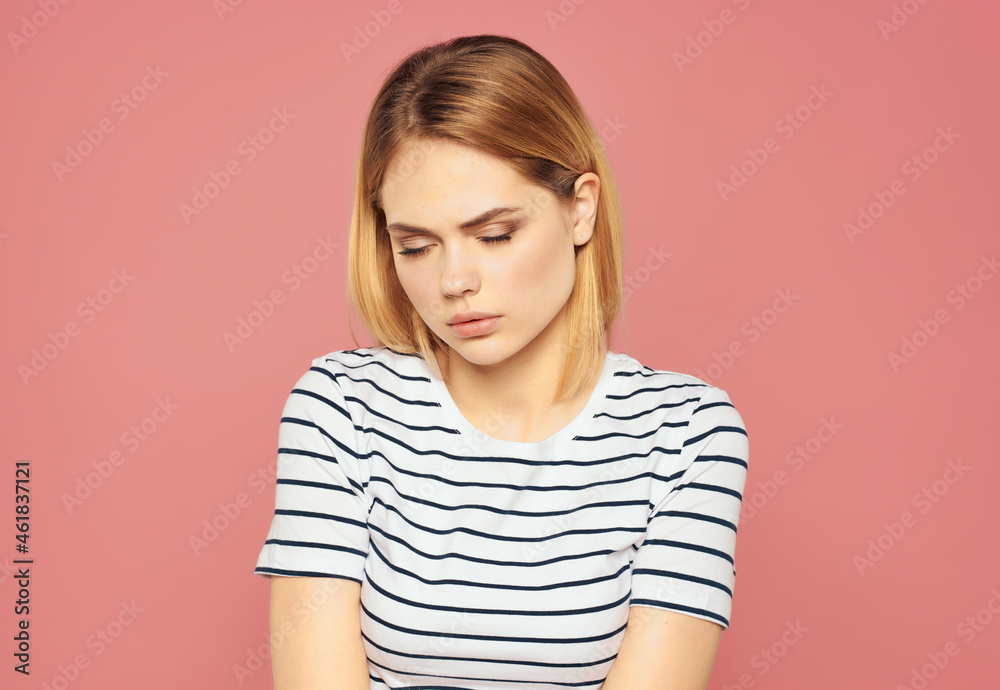 beautiful woman in a striped T-shirt discontent upset studio emotions beautiful woman in a striped T-shirt discontent upset studio emotions