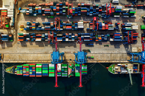 Logistics and transportation of Container Cargo ship and Cargo plane with working crane bridge in shipyard at sunrise, logistic import export and transport industry background
