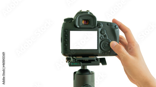 Hand taking pictures blank screen on isolated white background, Camera on a tripod, Photographer hands holding professional DSLR camera, Mockup image.