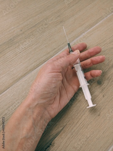 hand of drug addict with syringe