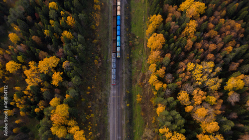 Aerial view of railway tracks and train in autumn.