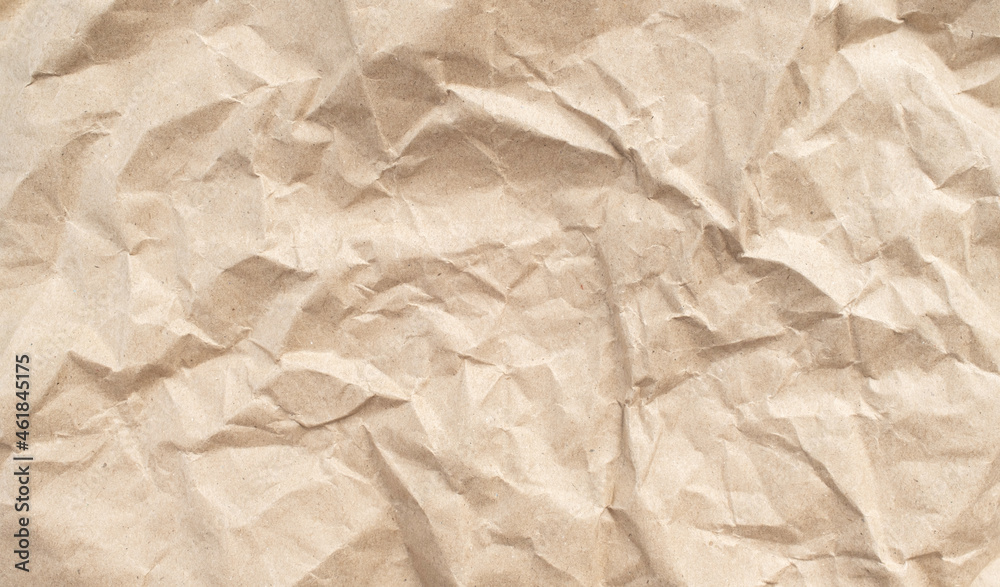 Recycled brown creased paper background from a paper packing. Crumpled brown paper texture concept Recycled brown creased paper background from a paper packing. Crumpled brown paper texture concept