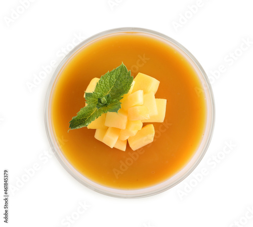 Delicious mango coulis with fresh fruit pieces and mint isolated on white