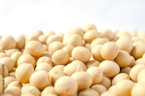 Closed up dry organic soybean seed pile on white background. Concept of healthy or diet food ingredient and agricultural product