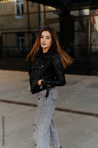 Close up portrait of cheerful pretty young woman in glamour stylish casual outfit posing walking summer day. Brunette wavy hairstyle. Looking at camera.