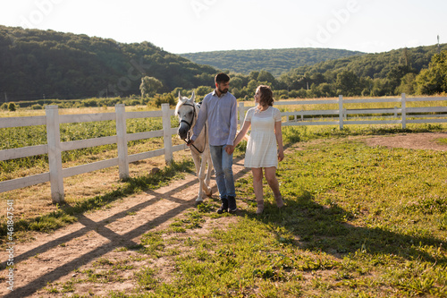 Couple walk at the ranch during summer day