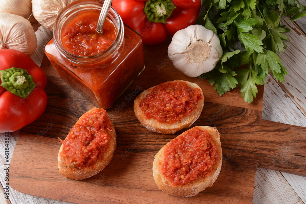 Ajvar, a delicious roasted red pepper and eggplant dish. Traditional macedonian serbian dish made from red bell peppers, eggplant and garlic, lutenitza, popular in Balkans Ajvar, a delicious roasted red pepper and eggplant dish. Traditional macedonian serbian dish made from red bell peppers, eggplant and garlic, lutenitza, popular in Balkans