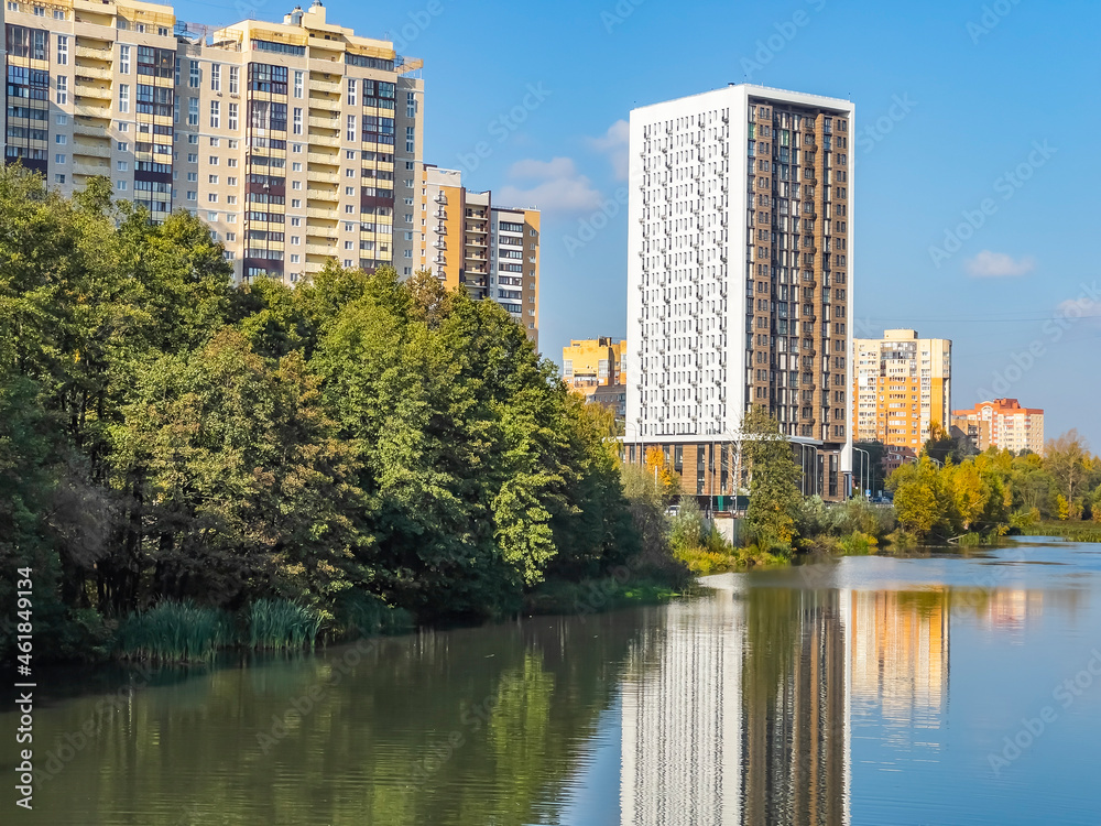 Pushkino, Russia, October 8, 2021. New multi-storey residential buildings on the banks of the Serebryanka river. Autumn landscape