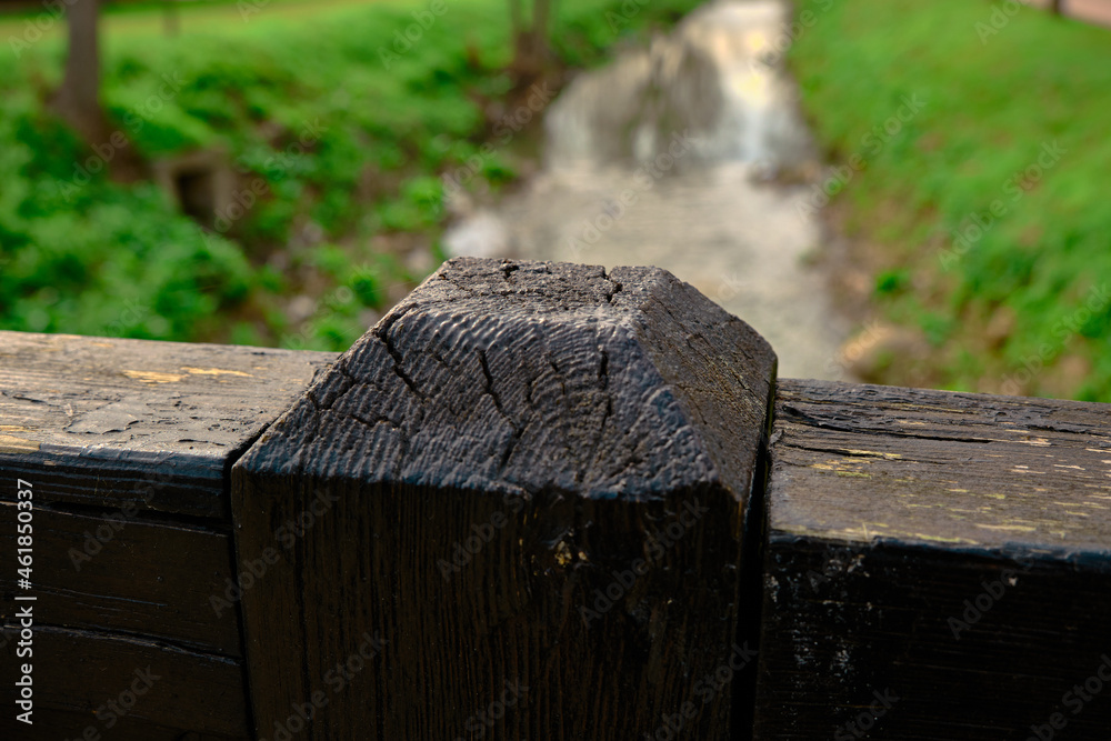 Fototapeta premium Cross type wooden columns and bridge parts in small shed in Bursa botanical park and water river background in forest background.