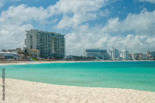 Beach sand with beautiful seascape and urban cityscape or luxury hotel buildings in the distant