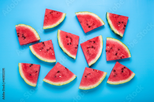 Slices of juicy watermelon on a blue background. Top view  flat lay