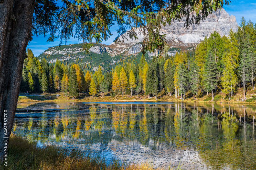 Fototapeta premium Autumn colors on the lake of Antorno. Magical glimpses of the Dolomites. Three peaks of Lavaredo