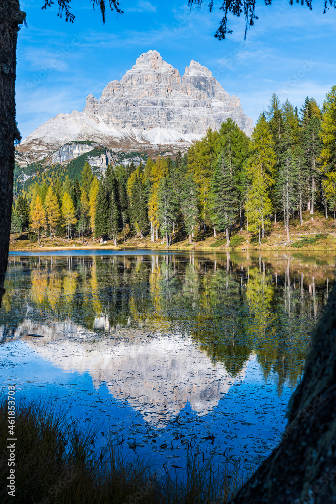 Autumn colors on the lake of Antorno. Magical glimpses of the Dolomites. Three peaks of Lavaredo