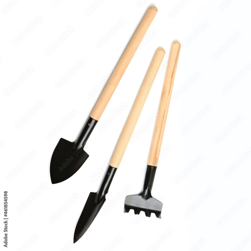 Set of miniature gardening tools isolated on white . Set of miniature gardening tools isolated on white .