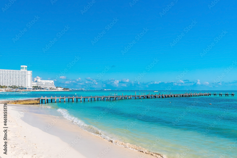 Scenic view beach and pier on sea with luxury hotel buildings at the coast against sky. Seascape and urban buildings against sky