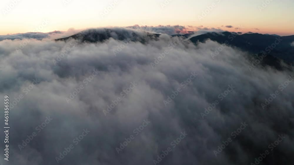 Aerial view of foggy sunrise in the mountains. Summer mountains. Aerial view of foggy sunrise in the mountains. Summer mountains.