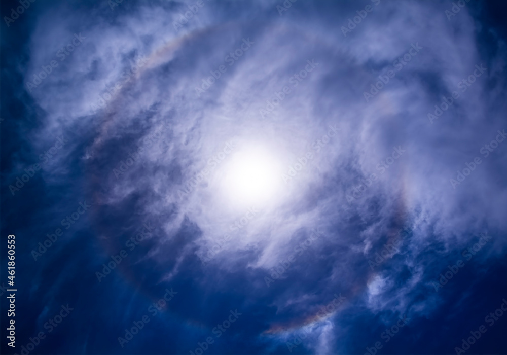 The colors of the solar halo hidden by the clouds, view from Sicily, Italy.