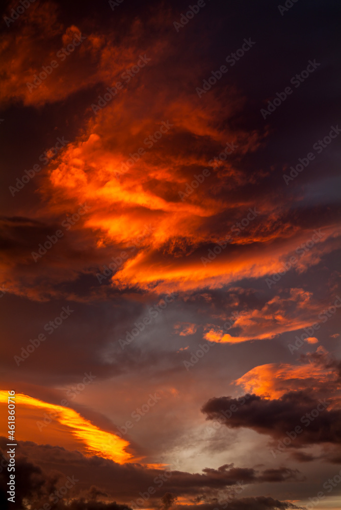Colorful sunset sky with dramatic orange clouds. Only sky, no land.
