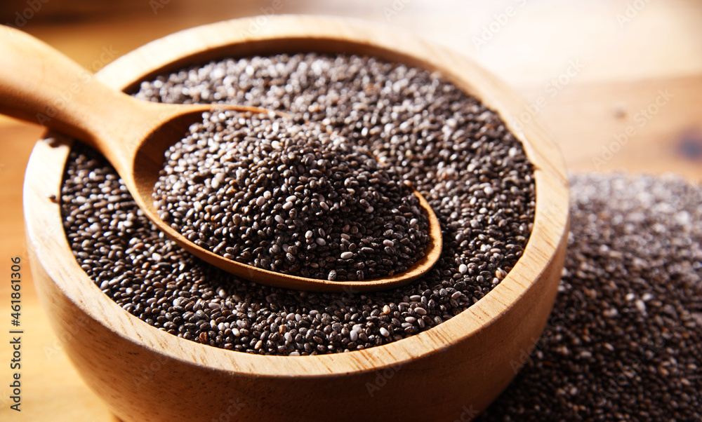 Bowl of chia seeds on wooden table Bowl of chia seeds on wooden table