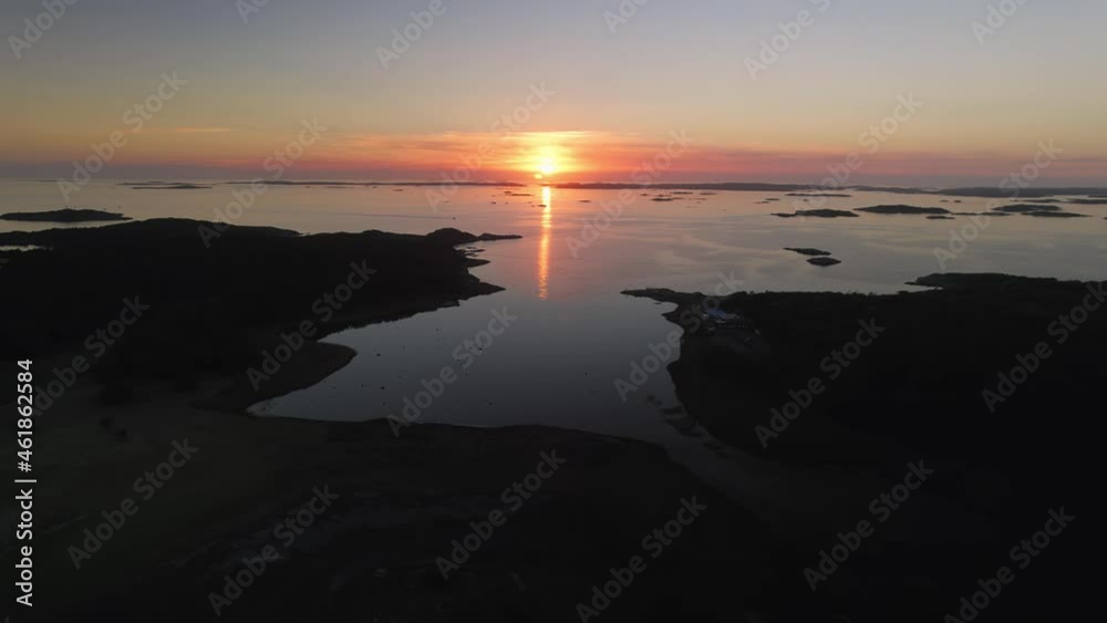Aerial view of a beautiful sunset over the sea behind the island Amundon in Gothenburg in autumn. 4k drone footage. Aerial view of a beautiful sunset over the sea behind the island Amundon in Gothenburg in autumn. 4k drone footage.
