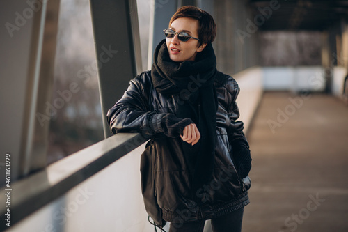 Woman in black jacket walking through the bridge