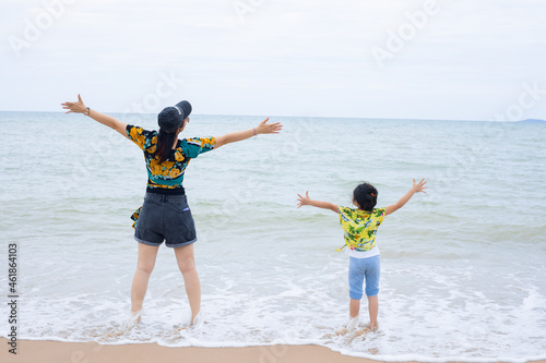Little girl and her mother during beach vacation © sticker2you