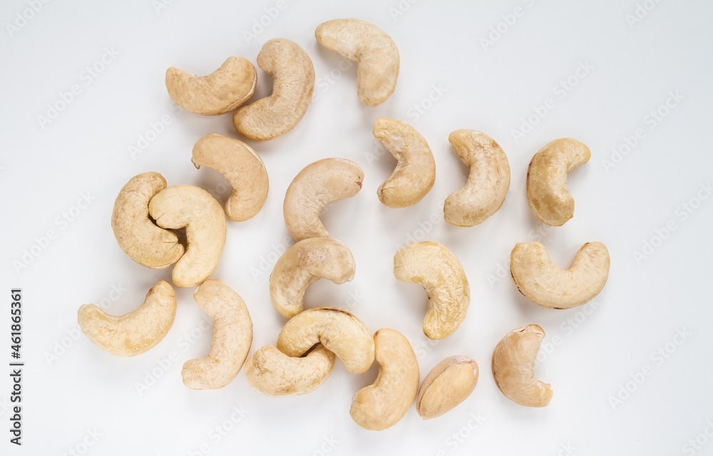 Cashew kidney-shaped nuts on a white background. Cashew kidney-shaped nuts on a white background.