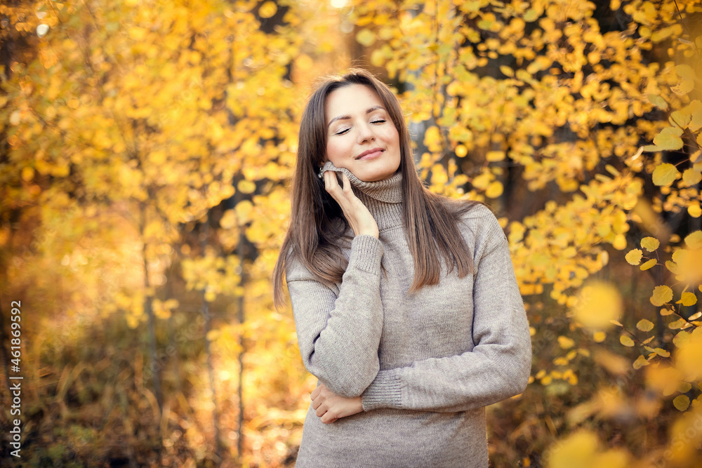 Portrait of a one happy dreamy beautiful woman enjoy on the street with eyes closed and fun cute smile on blurred background close up in autumn forest. Portrait of a one happy dreamy beautiful woman enjoy on the street with eyes closed and fun cute smile on blurred background close up in autumn forest.